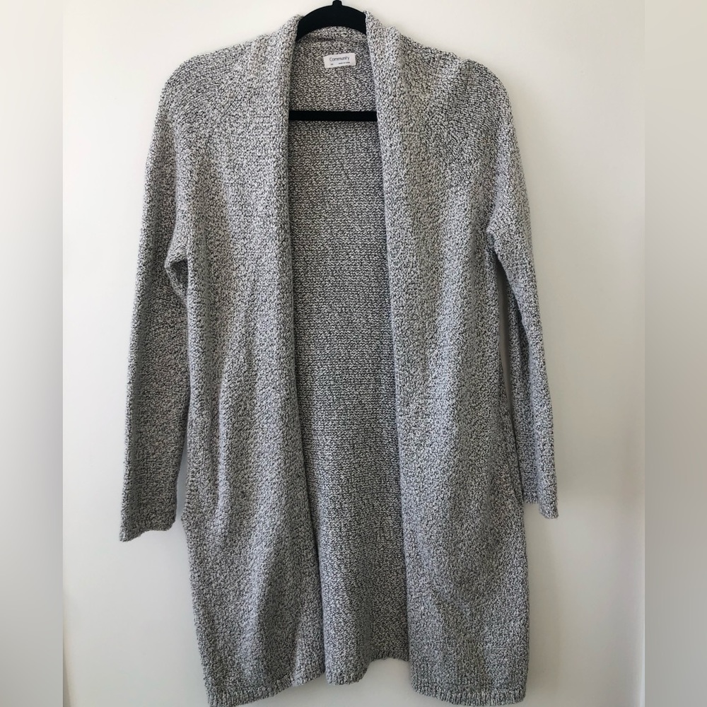 Black and white cardigan with pockets. Mid-thigh length, size XXS.